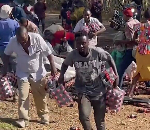 Like Nigerians, Kenyans Scramble For Packs Of Drink After Truck Overturns (Photos/Video)